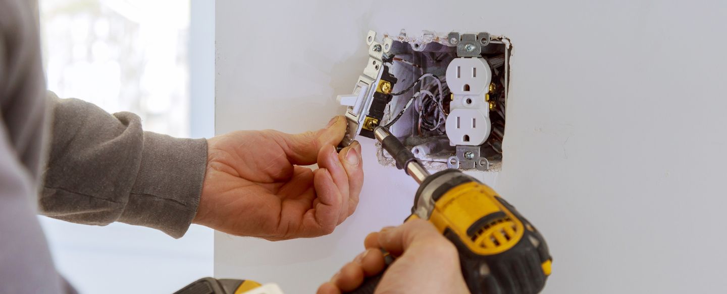 worker installing electrical outlets denver nc